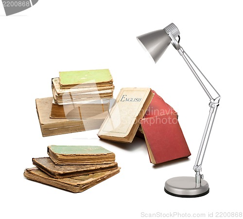 Image of books with a lamp