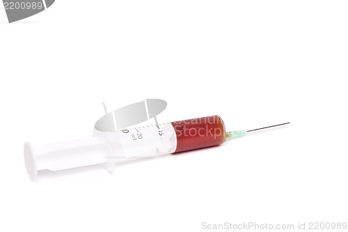 Image of syringe with red medication isolated on white background