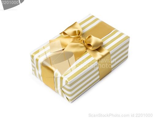 Image of Gift box in gold duo tone with golden satin ribbon and bow isolated over white background.