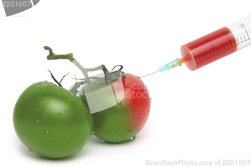Image of Filed syringe and green with red tomatoes