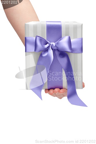 Image of male holding gift box with a bow isolated on white background