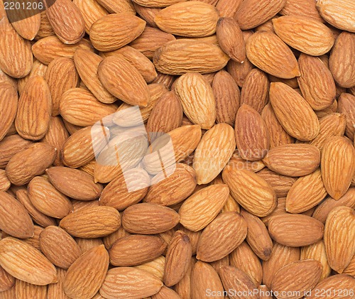 Image of Pile of almonds close-up as background.