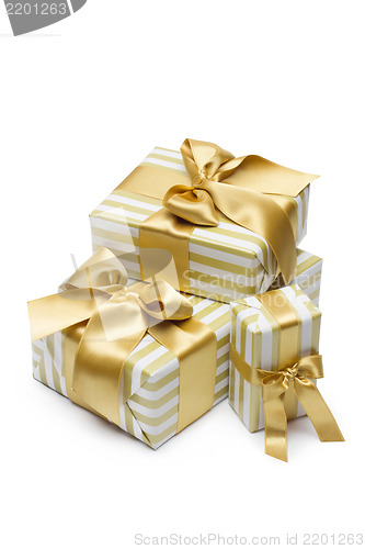 Image of Gold gift boxes isolated on white background