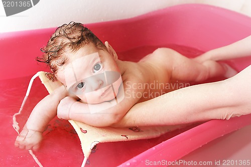 Image of baby is having a bath