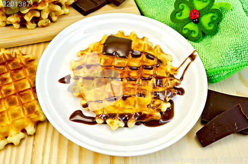 Image of Waffles circle with chocolate and green napkin