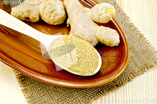 Image of Ginger fresh and dried on a clay plate and burlap