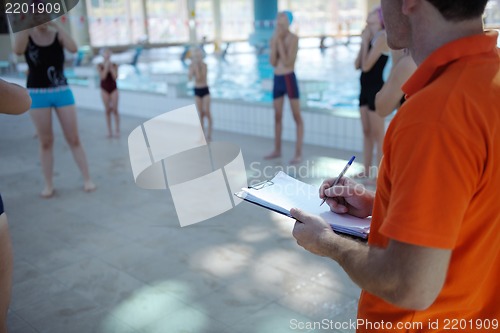 Image of happy children group  at swimming pool
