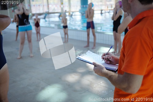 Image of happy children group  at swimming pool