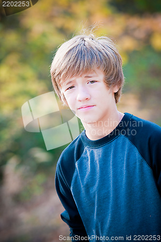 Image of Portrait of young teen looking at camera