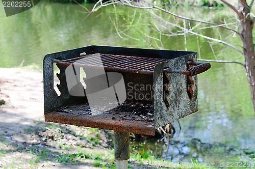 Image of Rusted charcoal grill at a Park