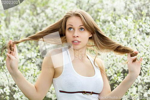 Image of Blonde playing with her hair