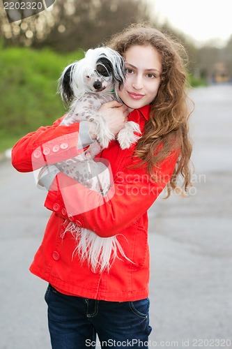 Image of Brunette hugging little dog