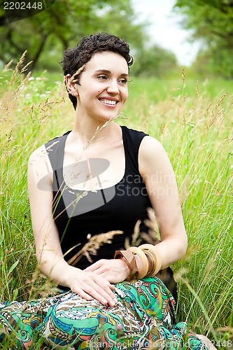 Image of girl resting on fresh spring grass 
