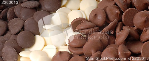 Image of Three types of chocolate chips, dark, white and semi-sweet