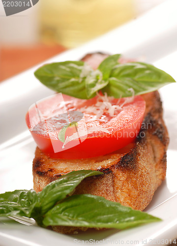 Image of Bruschetta topped with fresh tomato and basil