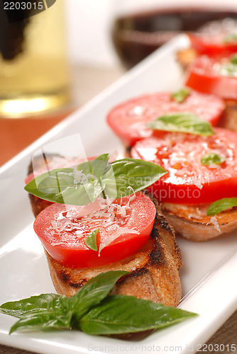 Image of Bruschetta topped with fresh tomato and basil