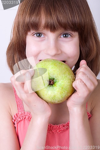 Image of child with a green apple