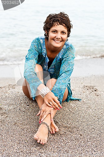 Image of woman in blue dress on the beach