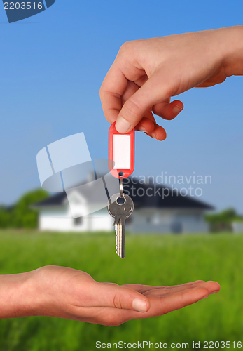 Image of Hands with Key to New House