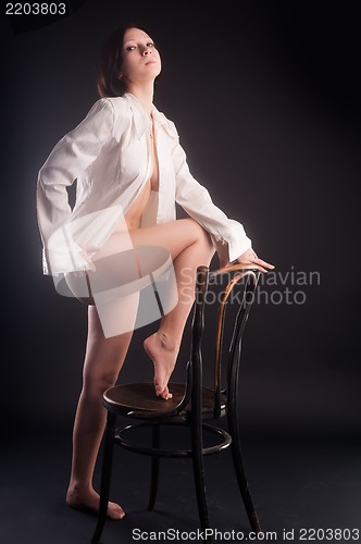 Image of young sexy woman in white shirt on chair