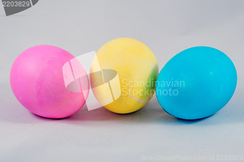 Image of three easter eggs pink  blue yellow