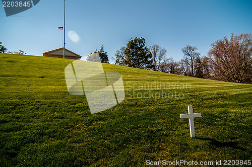 Image of white cross on a grassy hill