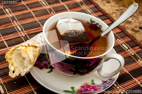 Image of cup of tea with pastry after dinner