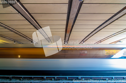 Image of metro train moving by at the station