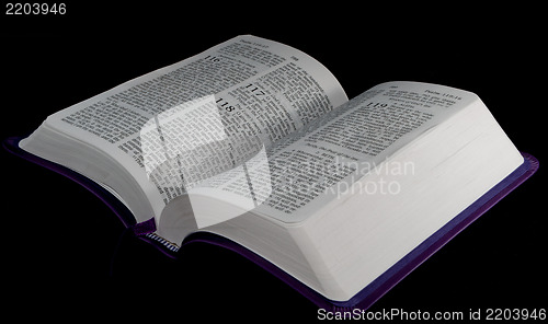 Image of open Bible to psalm 118 isolated on a black background.