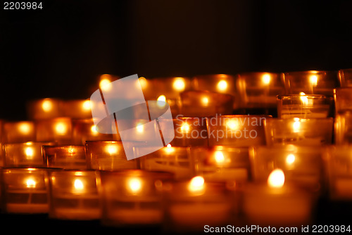 Image of Charity. Lignting of Praying candles in a temple.