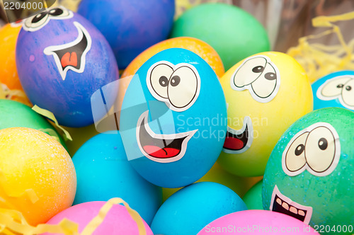 Image of smiley easter eggs in a holiday basket arrangement