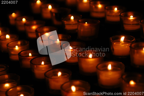 Image of Charity. Lignting of Praying candles in a temple.