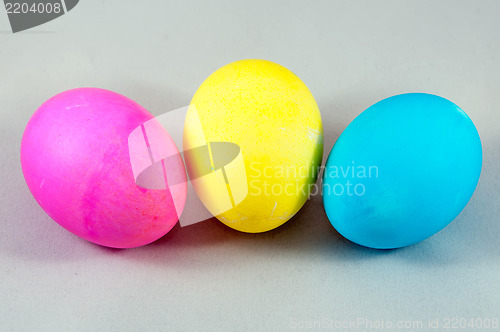 Image of three easter eggs pink  blue yellow