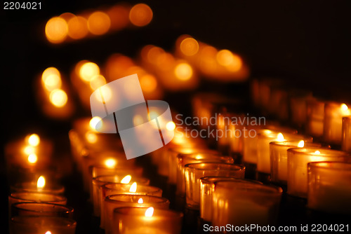 Image of Charity. Lignting of Praying candles in a temple.