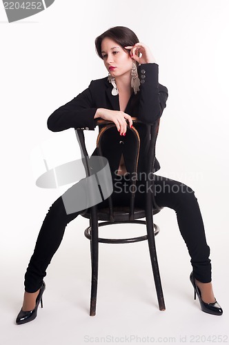 Image of young elegant woman on chair