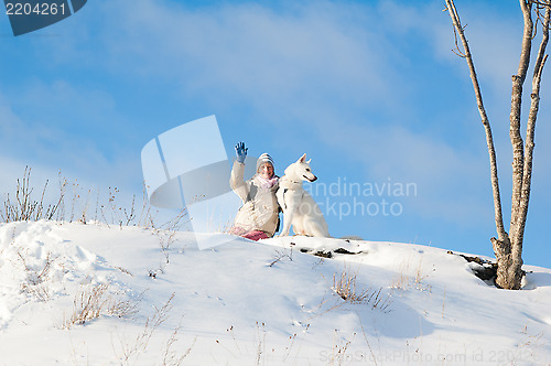 Image of The woman with a dog in winter on walk