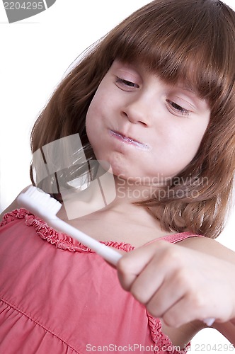 Image of girl brushing her teeth with a toothbrush