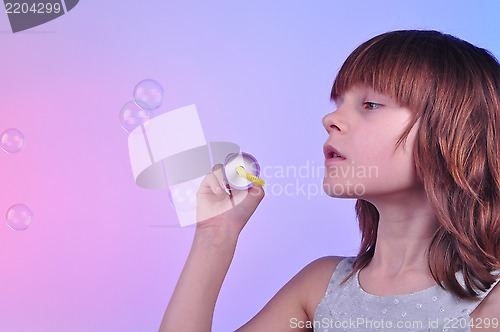 Image of girl blowing soap bubbles