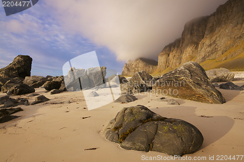 Image of Boulders on sandy beach