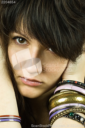Image of brunette lady with bracelets