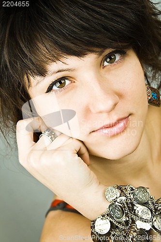 Image of young brunette lady with bracelets