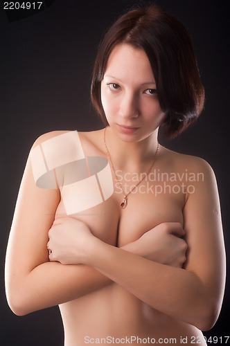 Image of topless woman body covering her breasts