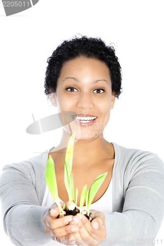 Image of Young Afro-American woman holding a growing plant