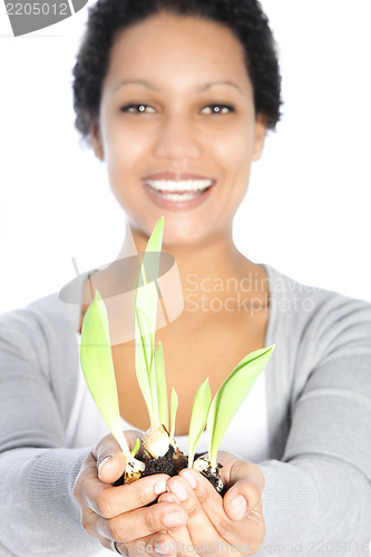 Image of Beautiful woman nurturing a spring bulb