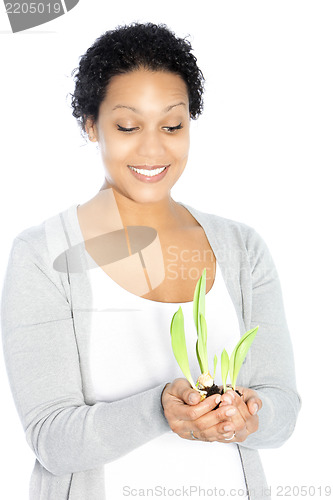 Image of African American woman hollding a plant