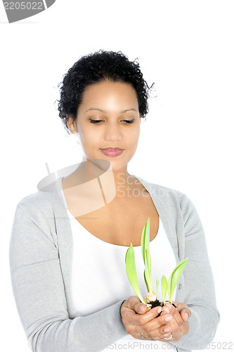 Image of Afro-American young woman holding a plant