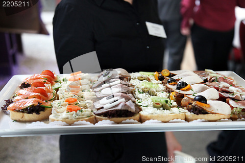 Image of Waiter offering a tray of appetizers