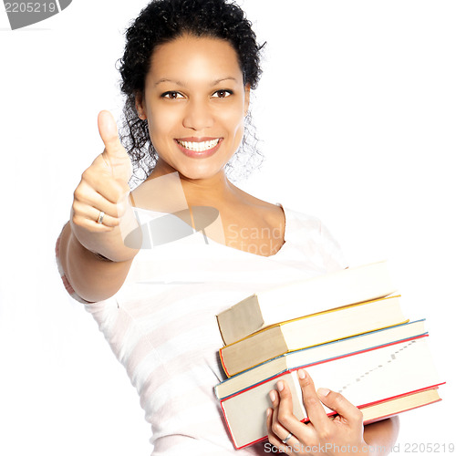 Image of Woman carrying textbooks giving a thumbs up