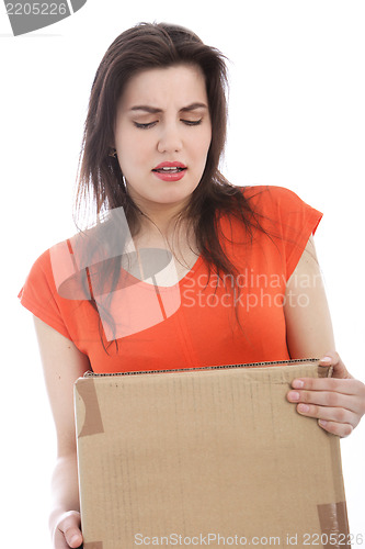Image of Young brunette woman carrying a cardboard box