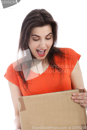 Image of Surprised young woman holding a cardboard box